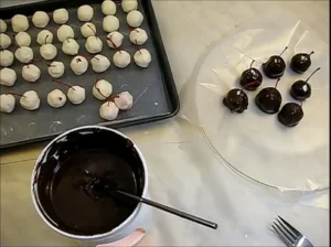 cherries dipping in caramel chocolate coating